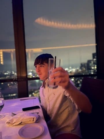 Colin at a high-floor Chicago restaurant at night