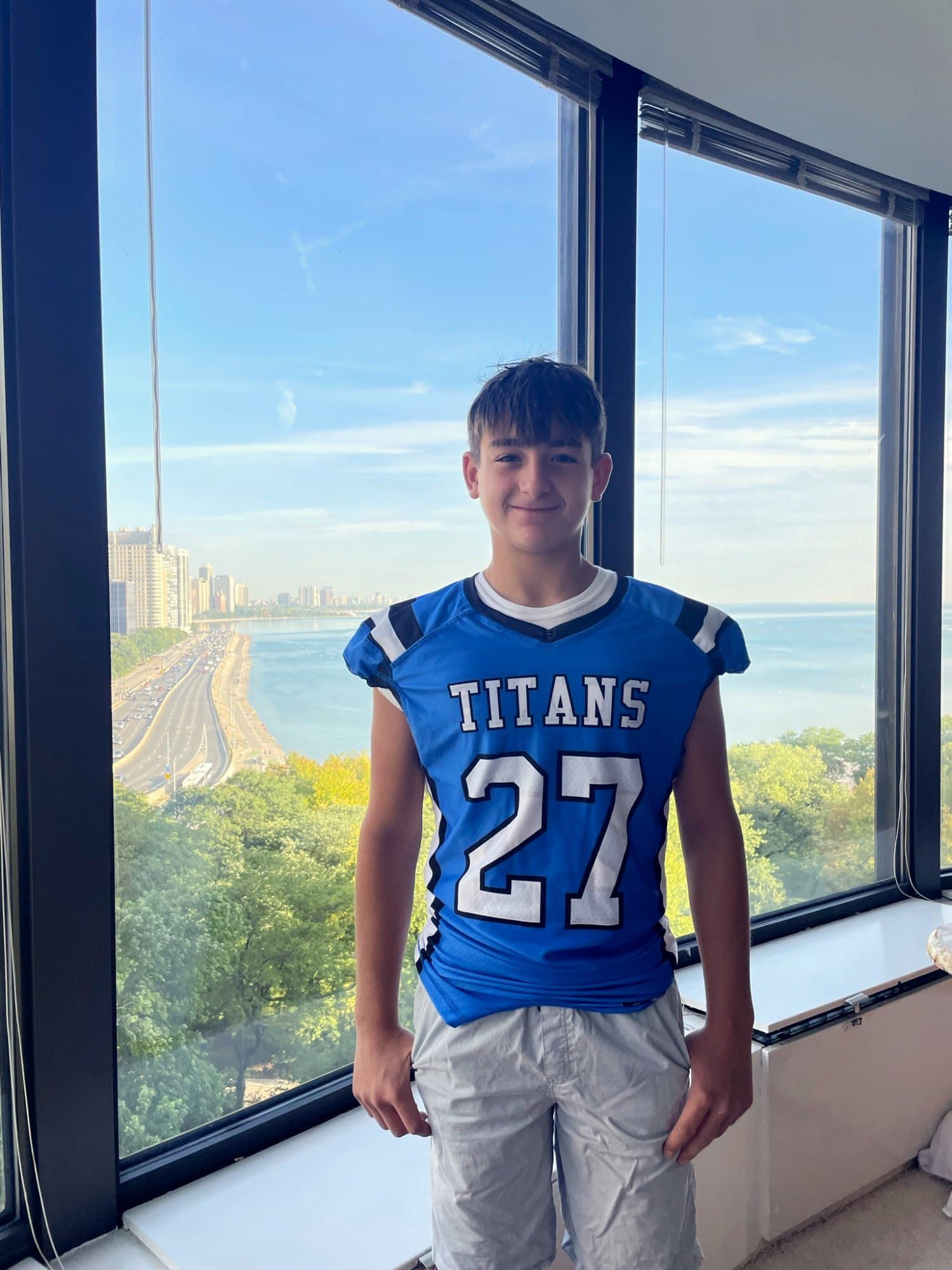 Colin in a Titans football jersey with Lake Shore Drive and the Chicago skyline behind him