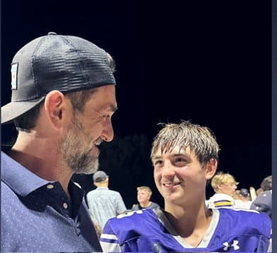 Colin in his Kiel football jersey with his dad after a night game