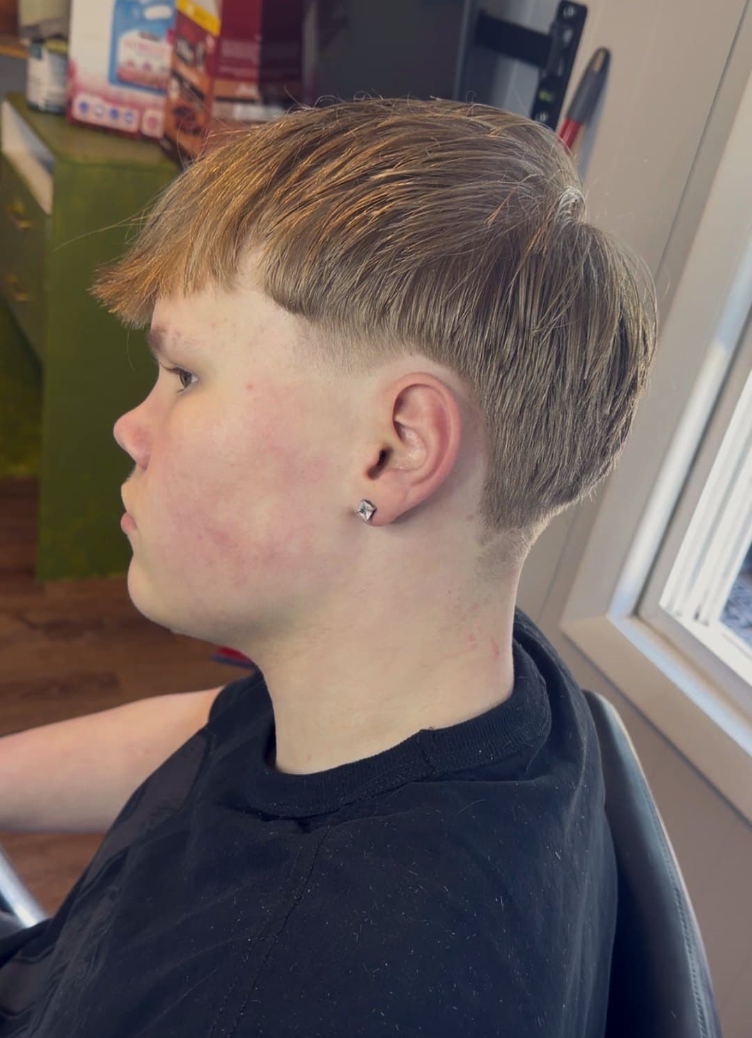 Mushroom-cut top fading to a clean low taper, side profile