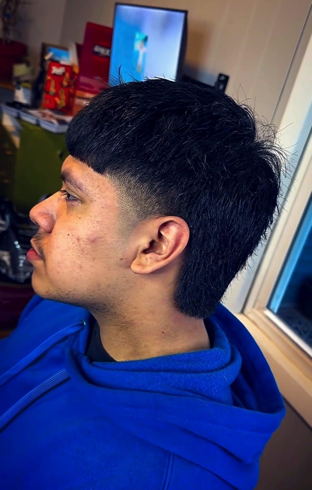 Modern mullet with a low fade and crisp temple line, side profile